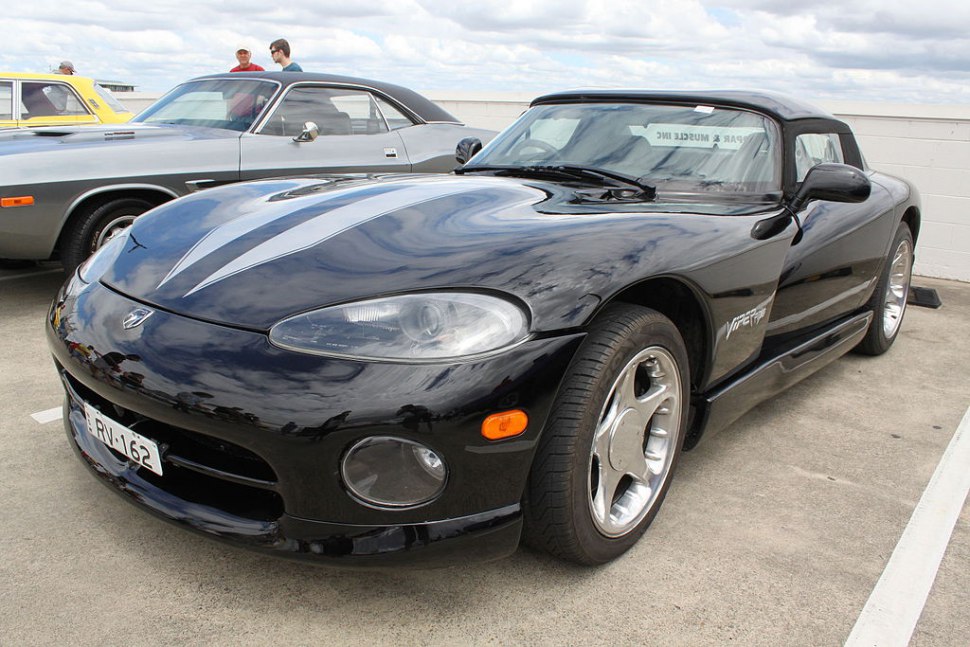 Black sports coupe with sleek aerodynamic body and prominent headlights