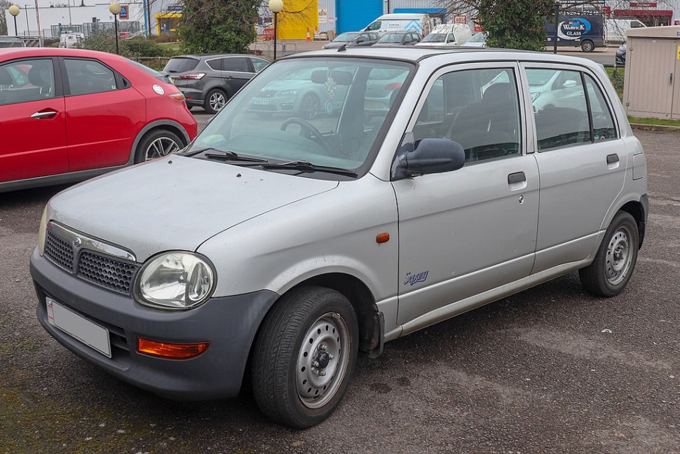 Compact hatchback with rounded headlights and black plastic bumpers