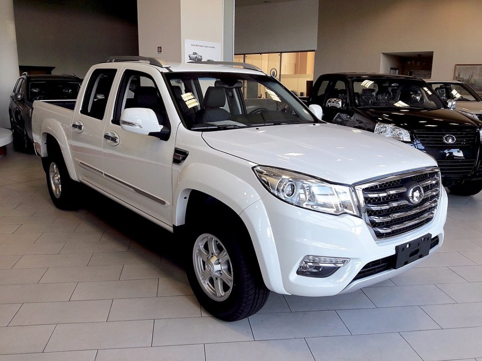 Front angled view of double cab pickup with chrome grille and LED lights