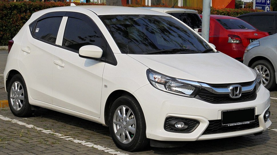 White compact hatchback with sleek headlights and sporty front design