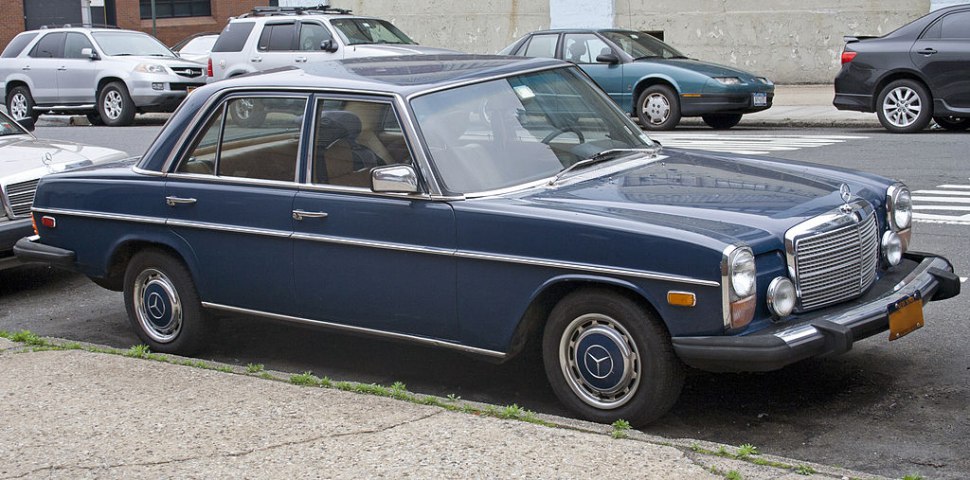 Vintage sedan with round headlights and chrome grille design