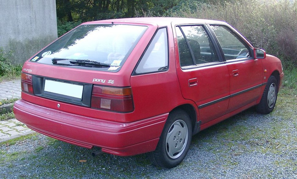 Red 1989 hatchback car rear and side view