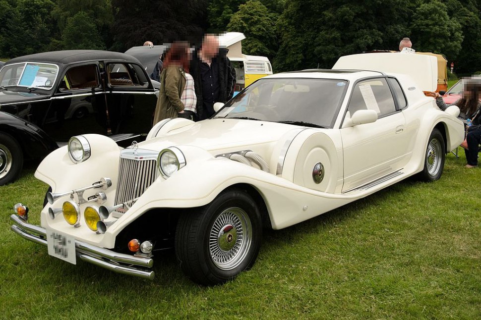 Retro-style classic vintage car with round headlights and prominent front fenders