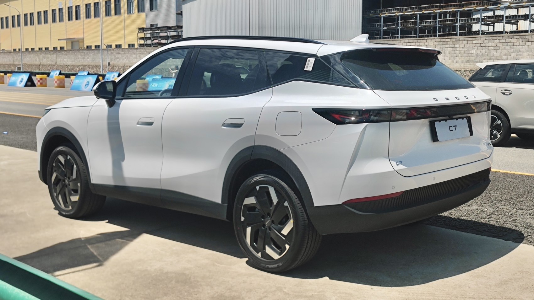 Rear-side view of a white SUV with sharp LED taillights and alloy wheels