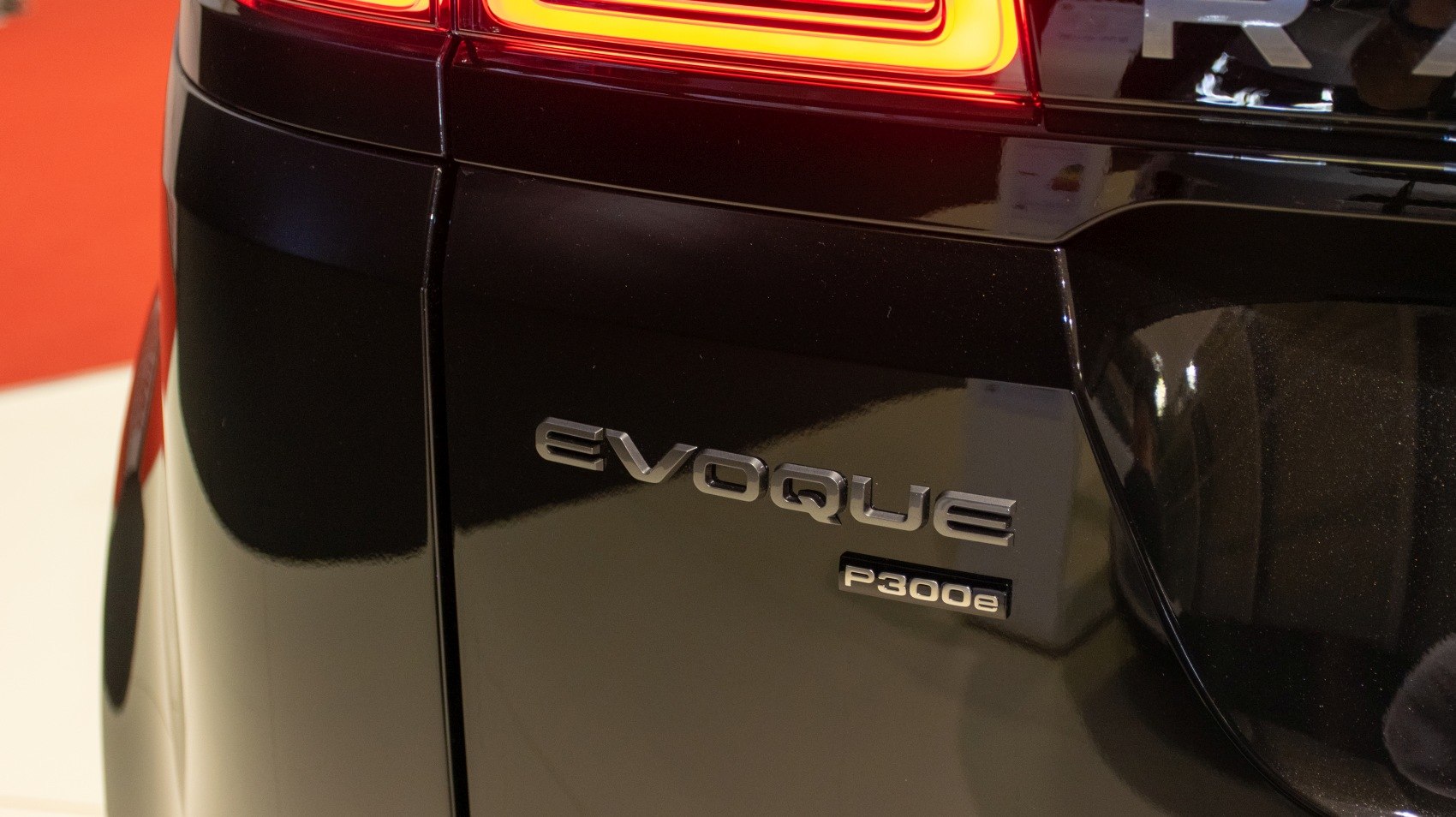 Close-up of rear badge and illuminated tail light.