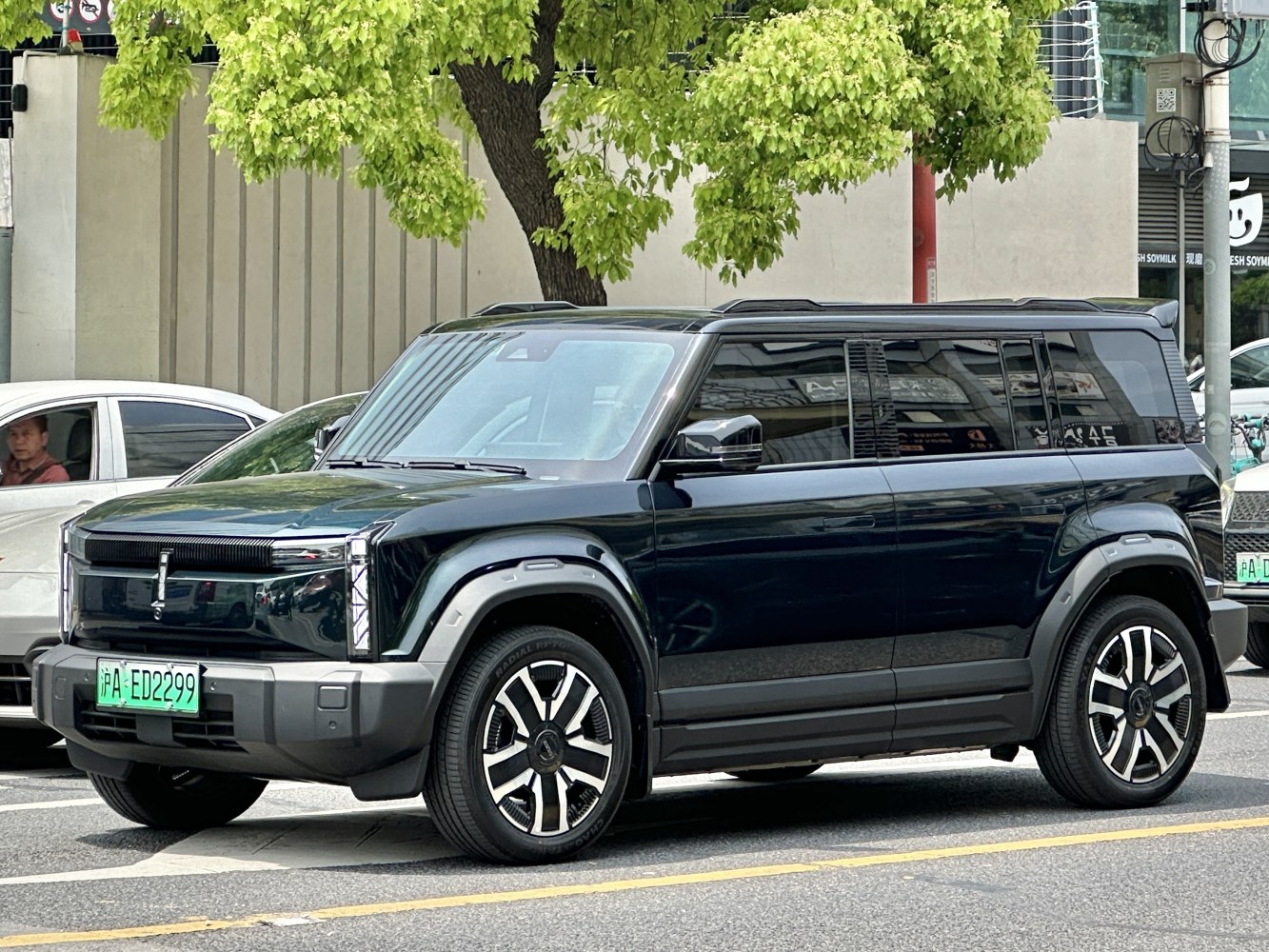 Front side view of sleek boxy electric SUV with multi-spoke wheels