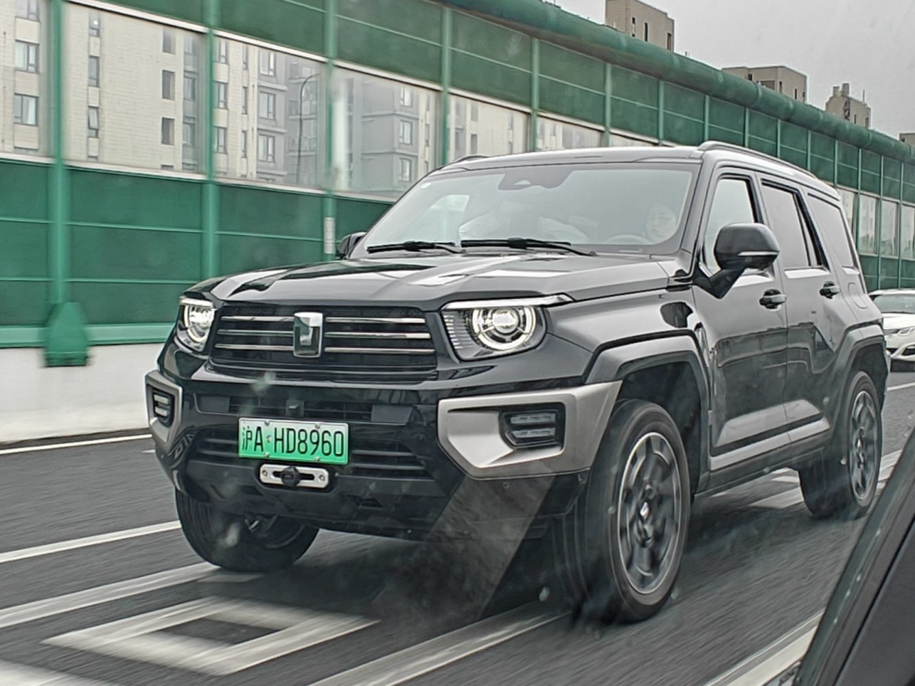 Black SUV with modern LED headlights and robust grille on road