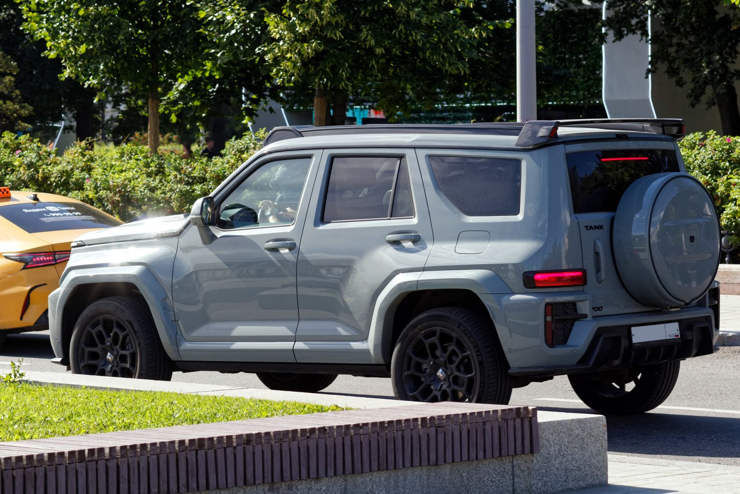 Rear side profile of SUV with spare tire cover and rugged design