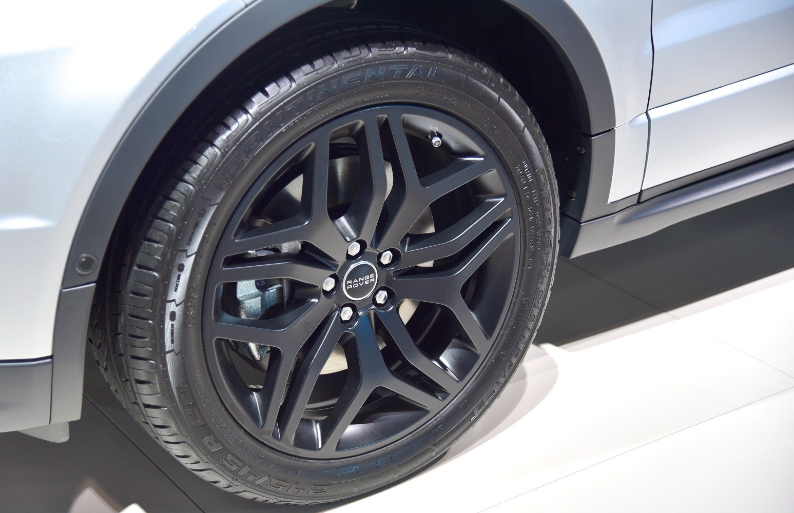 Close-up of a black alloy wheel with Continental tire