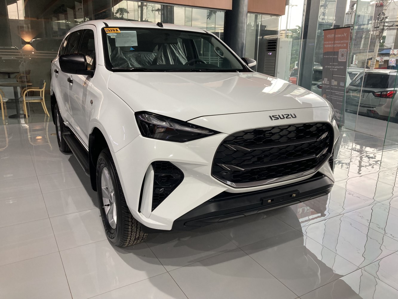 Front grille and sleek sharp headlights of modern SUV