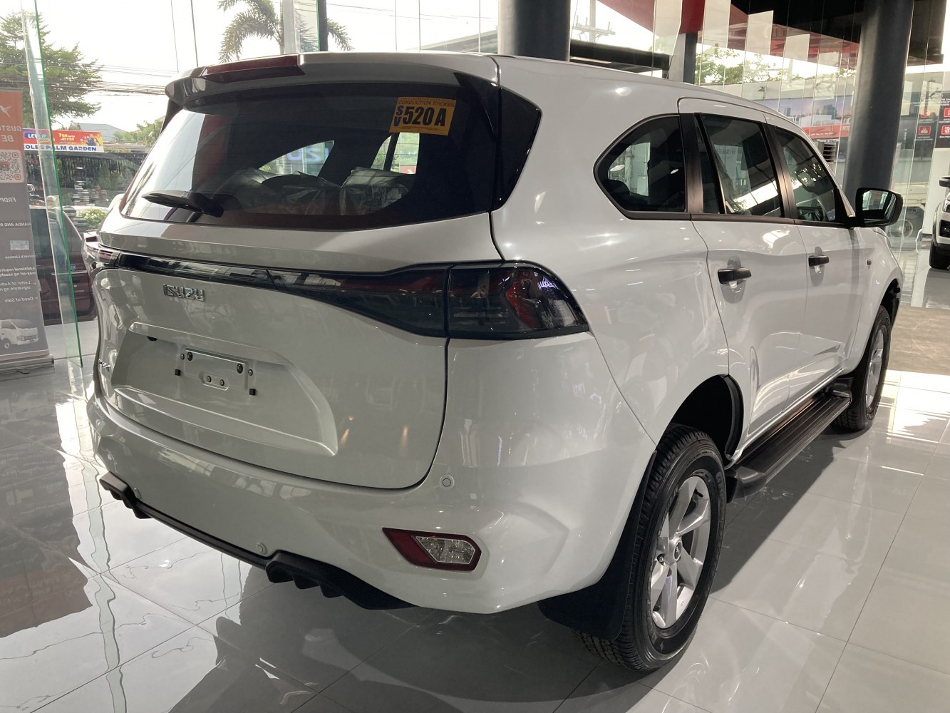 Rear view and side profile of a modern white SUV with sleek tail lights