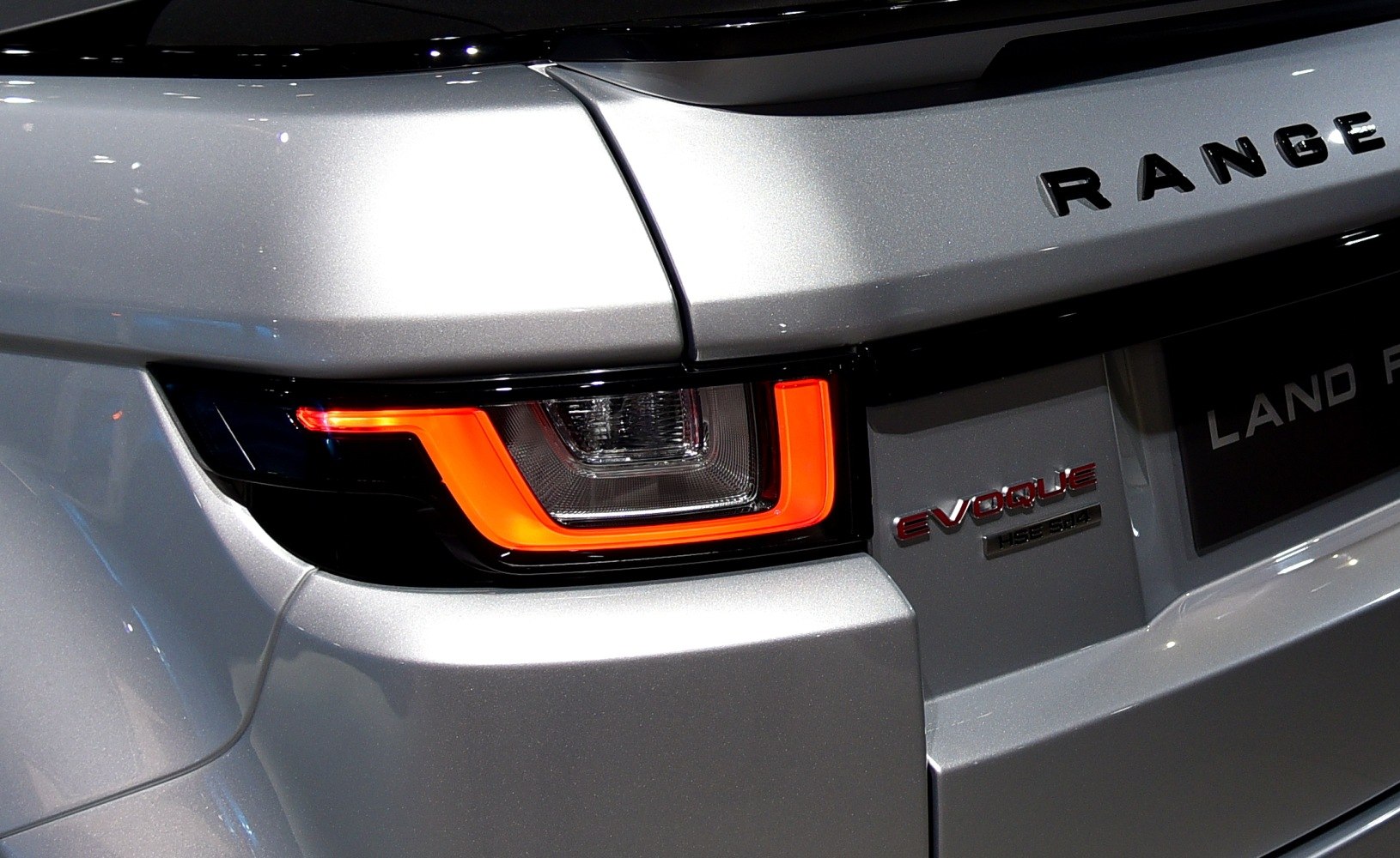 Close-up of rear light and badge of a car.