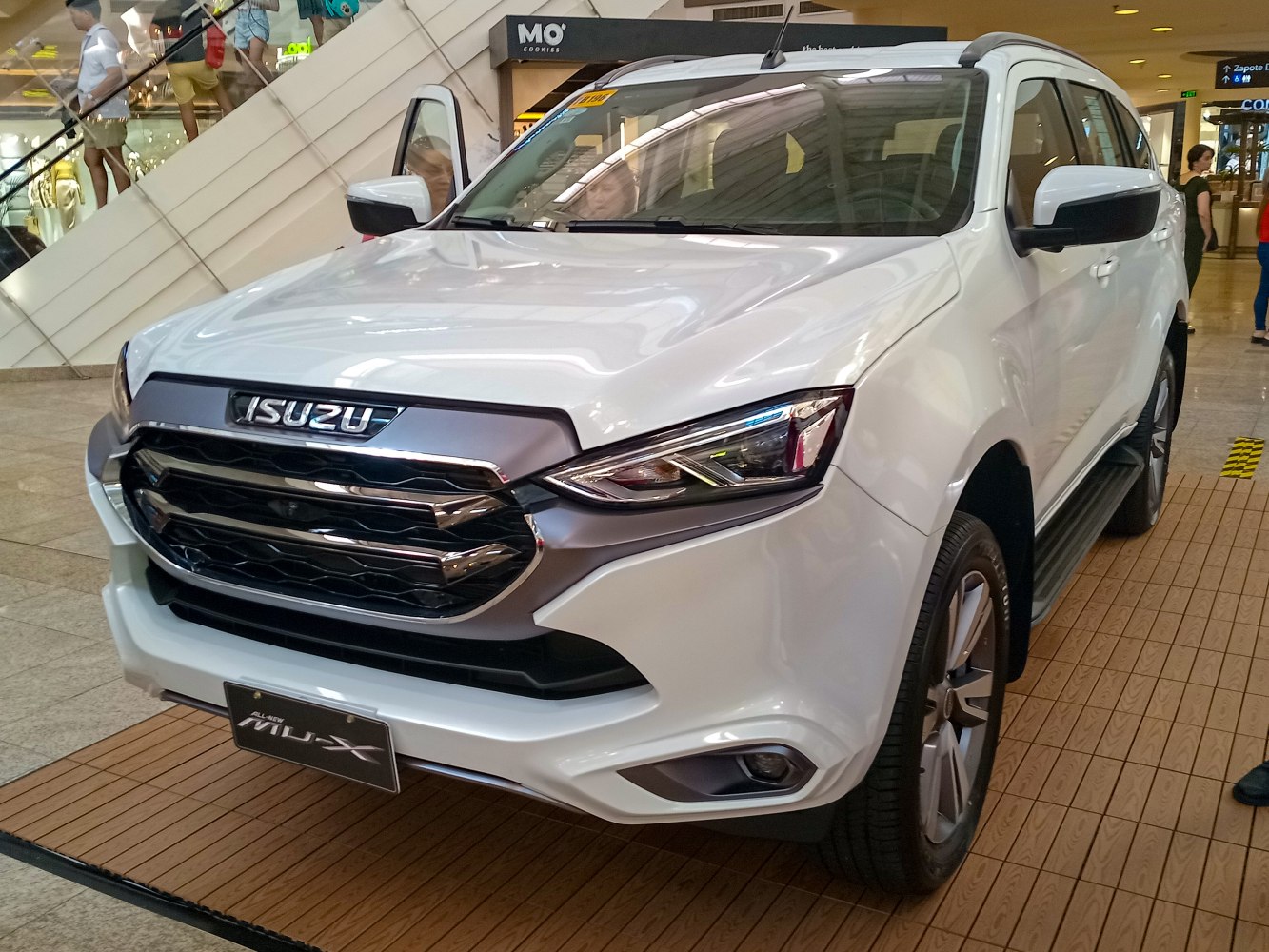 Front view of white SUV with bold grille and LED headlights