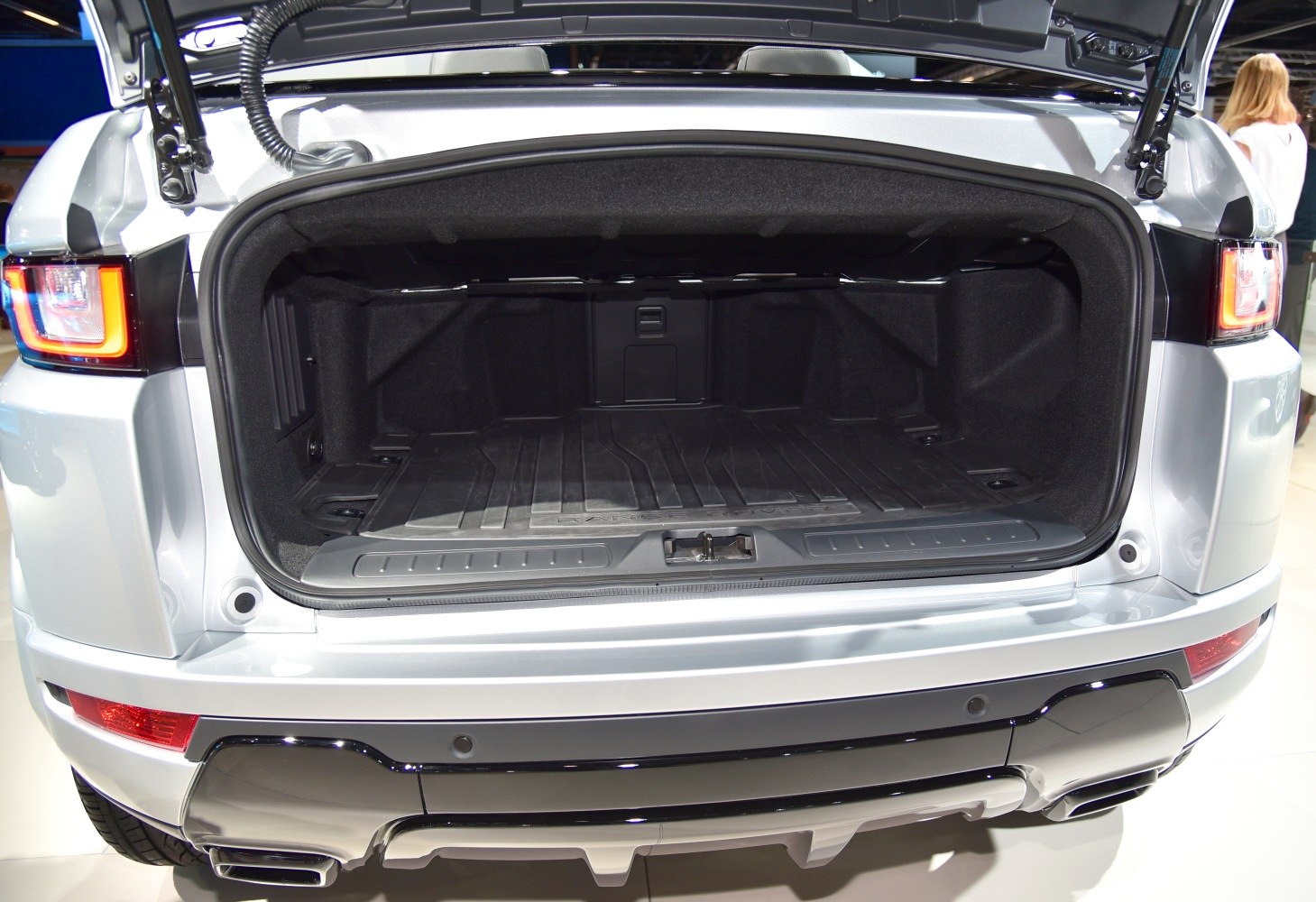 Open trunk cargo space of a modern SUV with a protective floor mat.