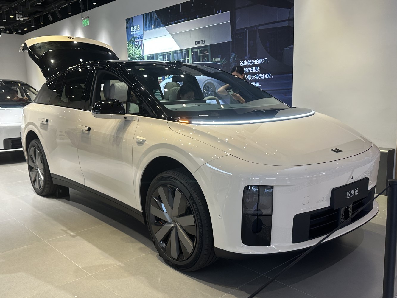 Futuristic electric SUV with aerodynamic wheels and advanced lighting.