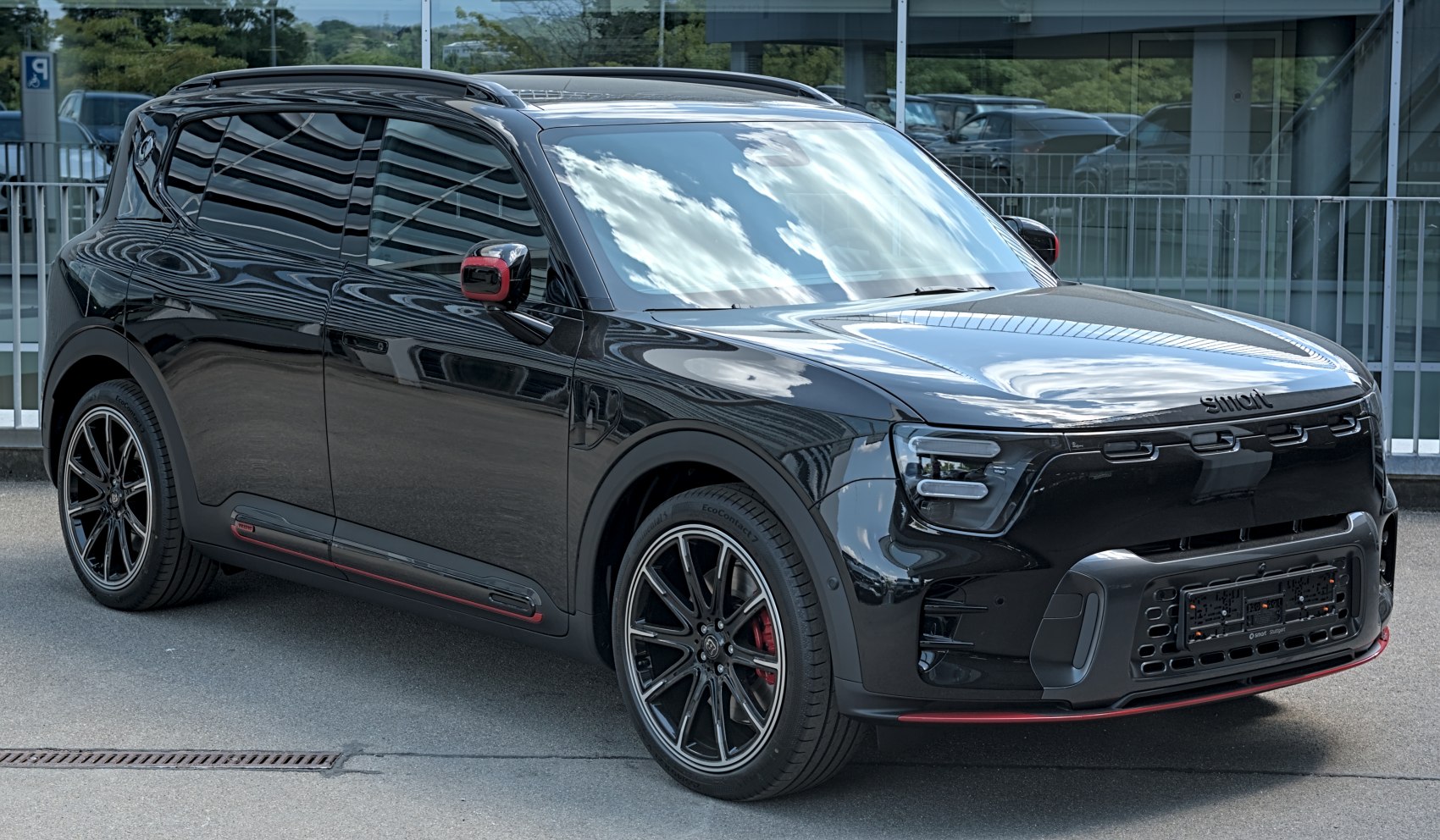 Front and side view of a sleek black compact electric SUV with LED headlights and alloy wheels