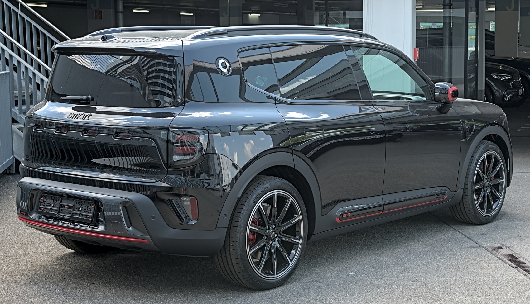 Rear-side view of a sleek crossover SUV with tinted windows and sporty wheels