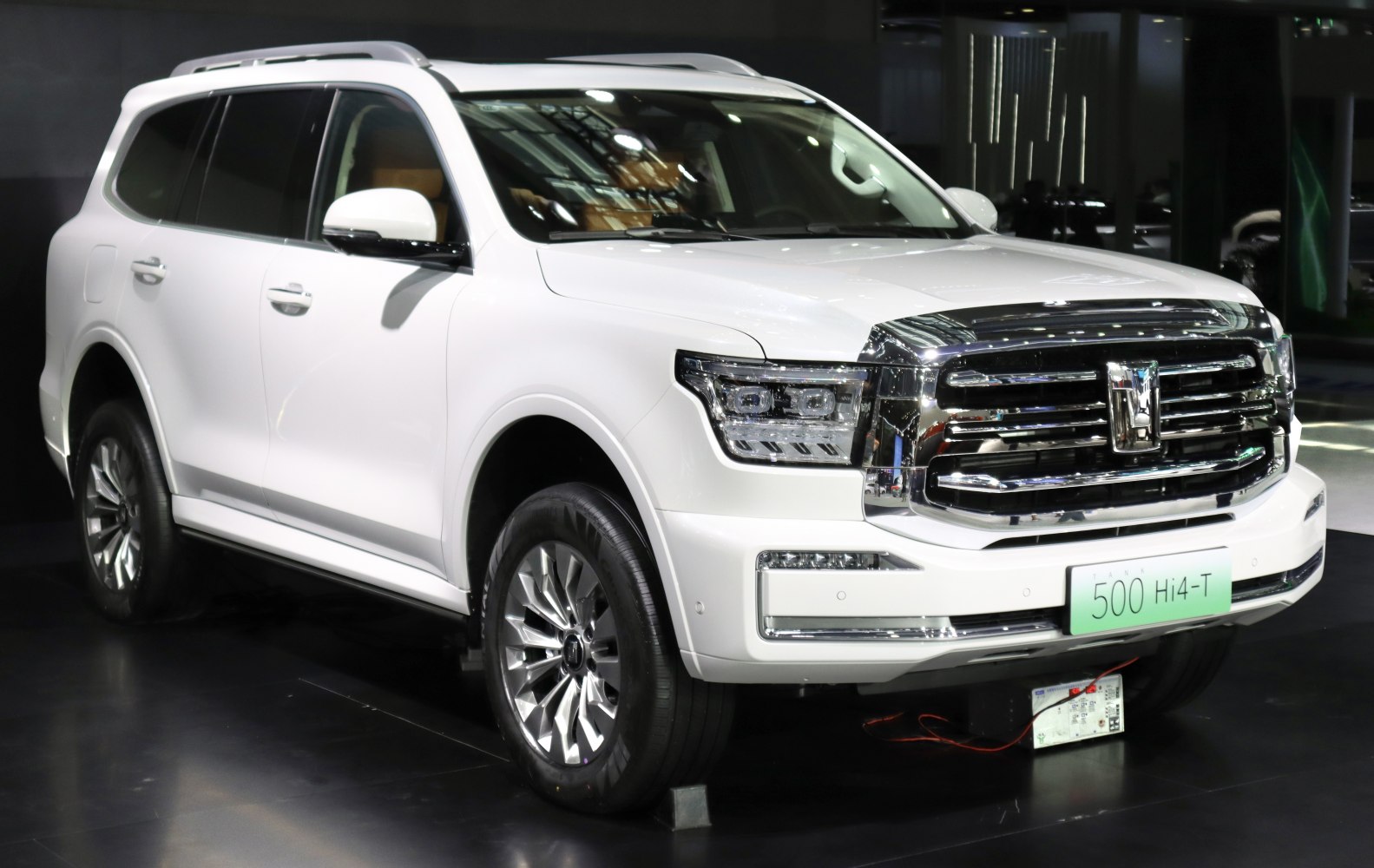 Front grille and LED headlights of a white luxury SUV