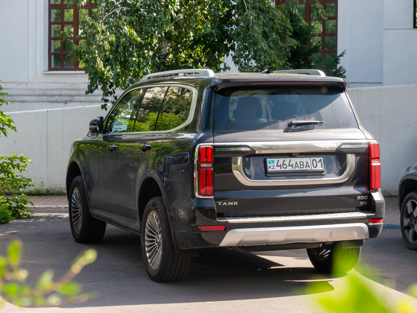 Rear view of full-size SUV with vertical LED taillights and roof rails