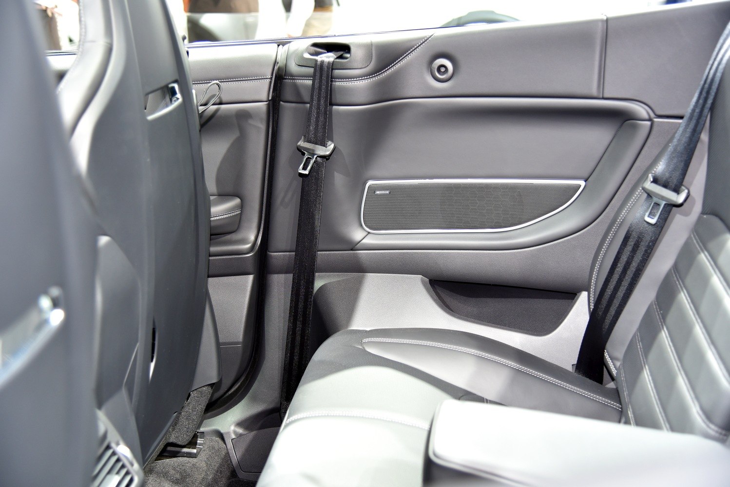 Rear leather seats and door panel with integrated Meridian speaker and seat belts.