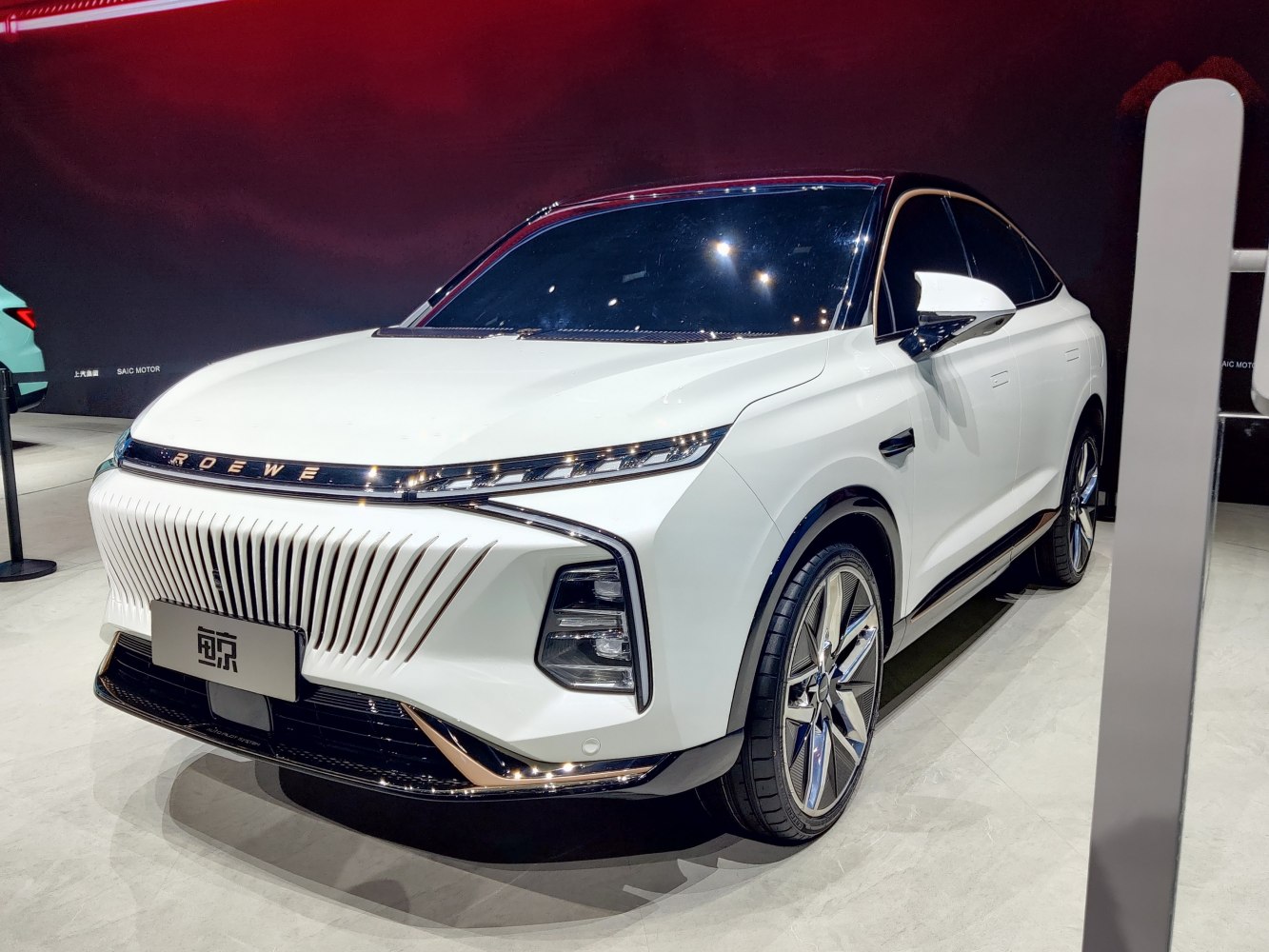Futuristic front grille with sharp LED headlights on a modern SUV.