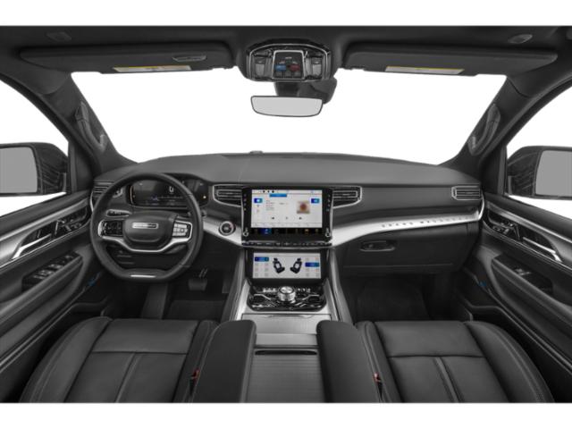 Dual touchscreen dashboard and steering wheel in luxury SUV interior