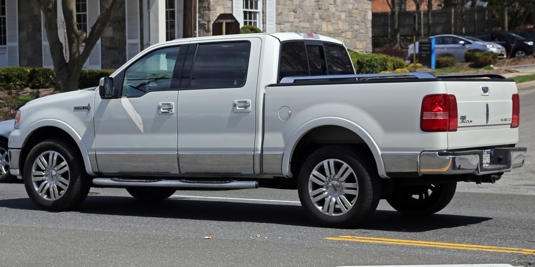 Side view of a luxury crew cab pickup truck with alloy wheels