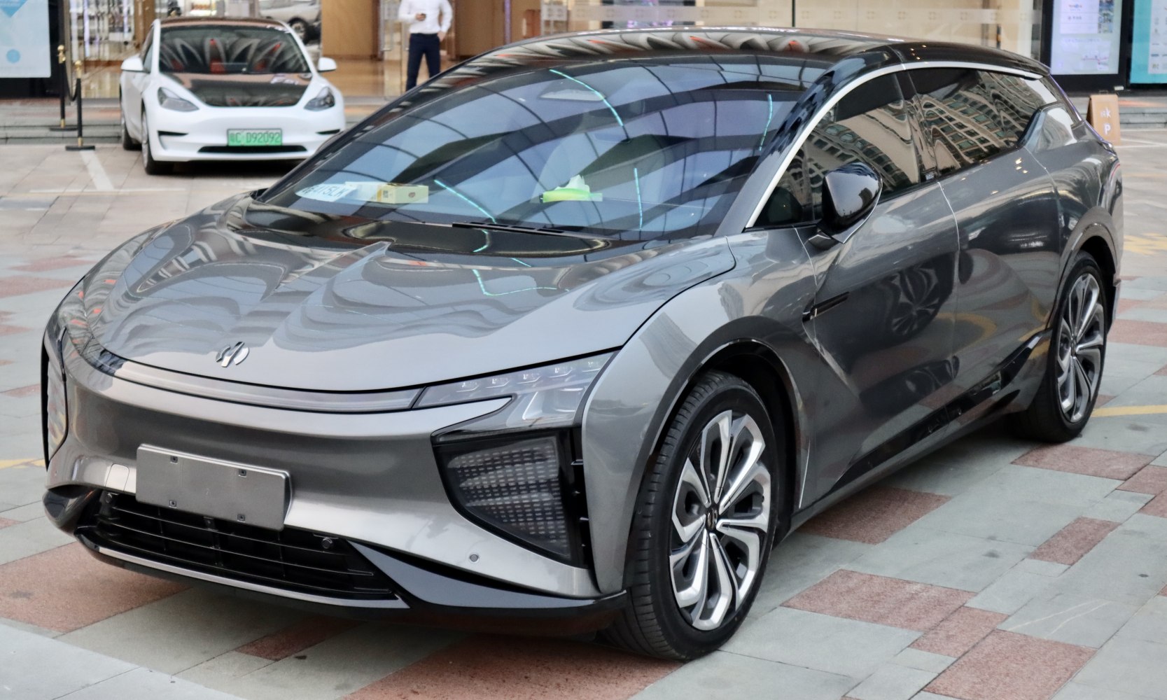 Front side view of sleek electric SUV with LED headlights and modern wheels