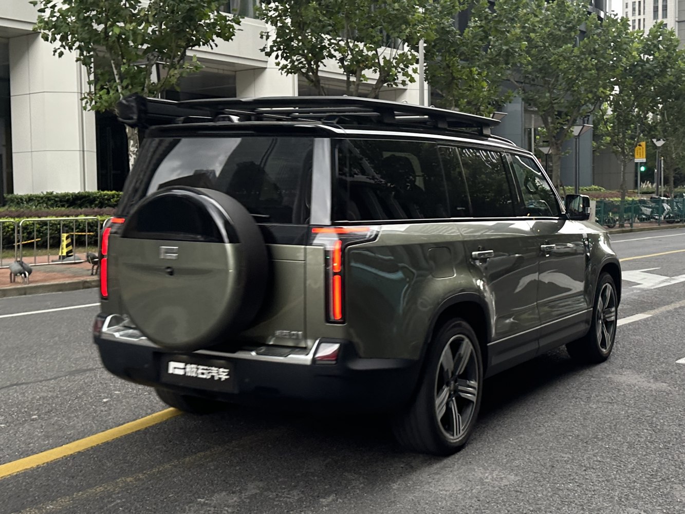 Rear view of SUV with spare wheel cover and roof rack