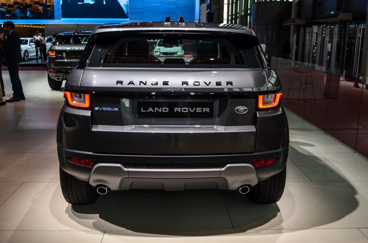 Rear view of SUV with illuminated tail lights and dual exhaust pipes
