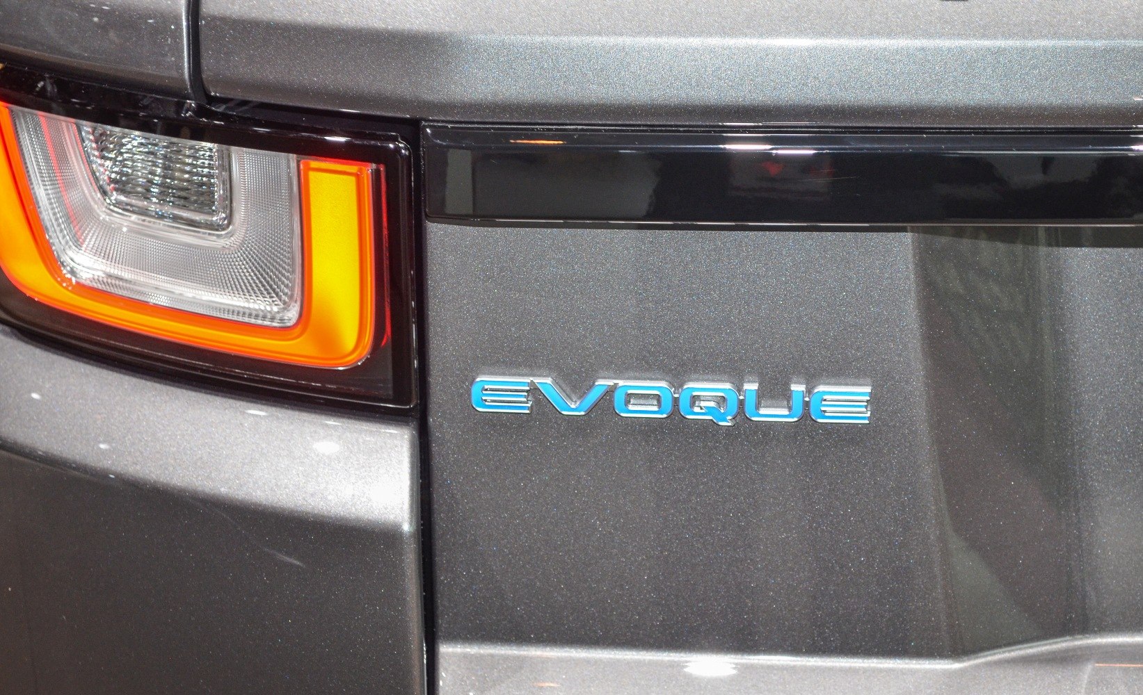 Rear taillight and EVOQUE badge on dark metallic surface