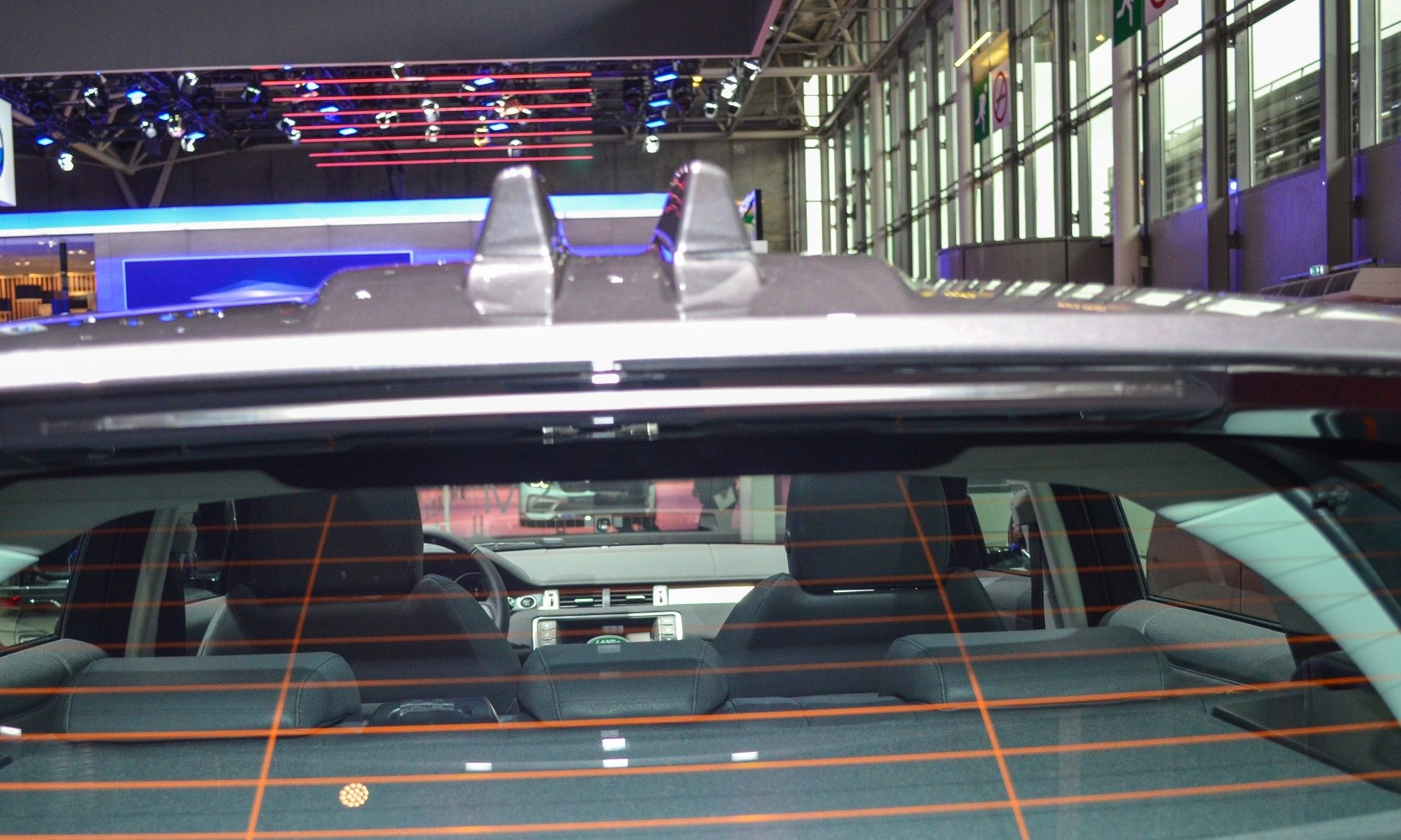 Rear window with defroster lines and interior seats visible
