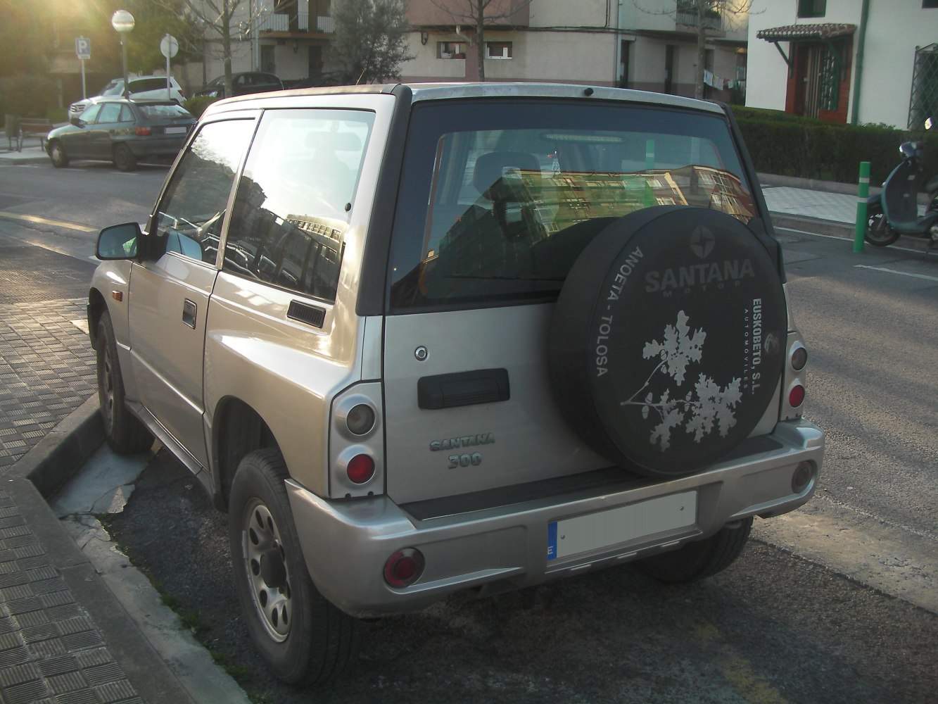 Rear view of compact SUV with spare tire cover and boxy design