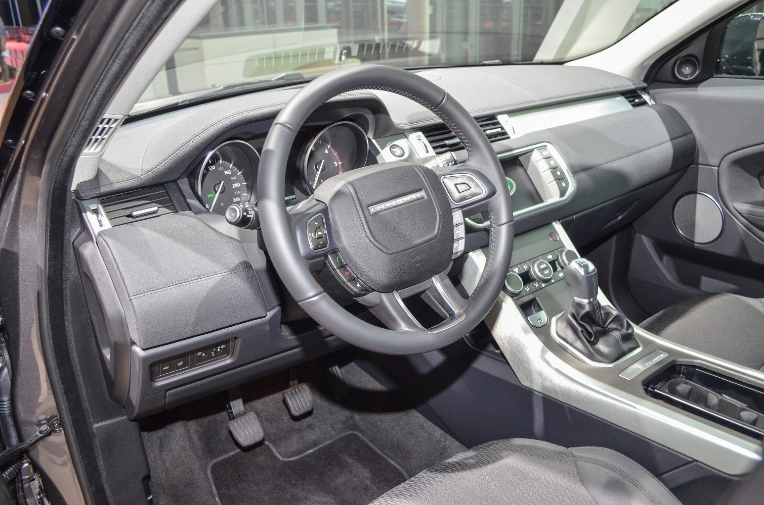 Steering wheel, manual gear shift, and dashboard interior of luxury SUV