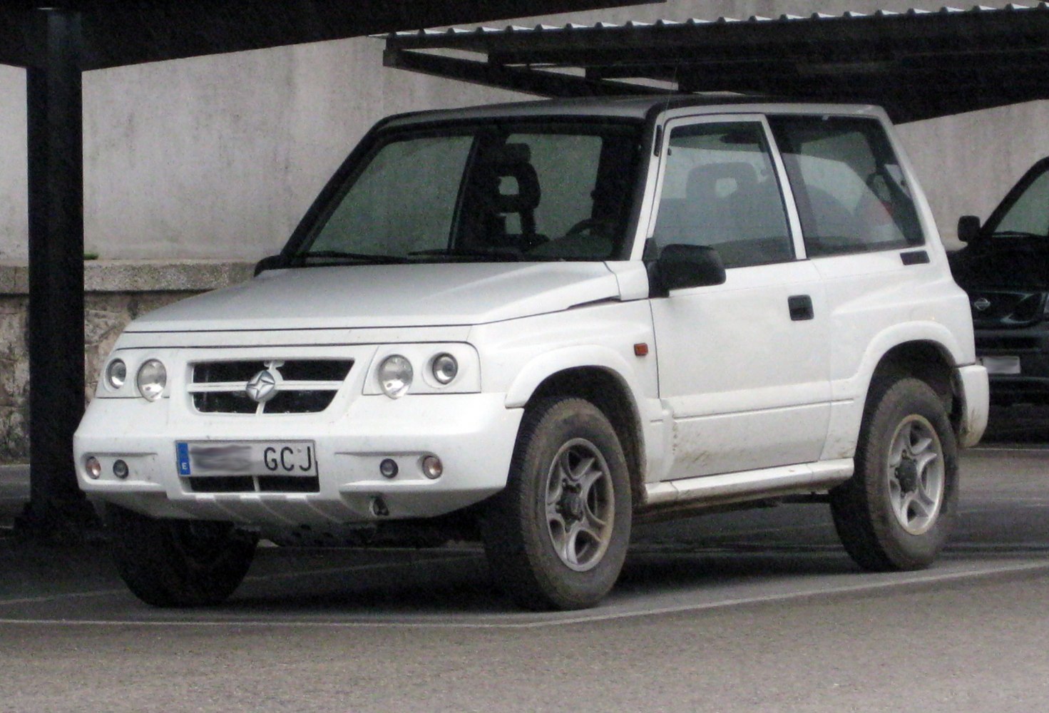 Compact SUV with dual round headlights and rugged tires