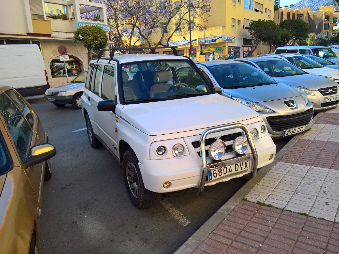 White SUV with front bull bar and dual off-road lights