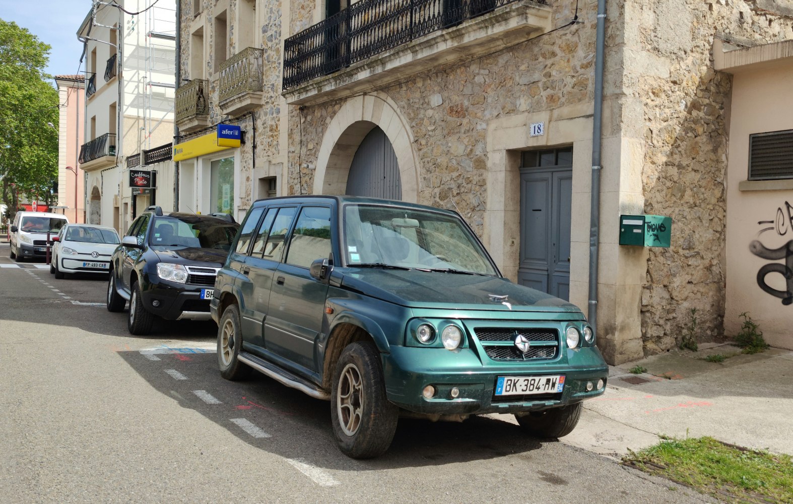 SUV with distinctive front grill and round headlights parked on street