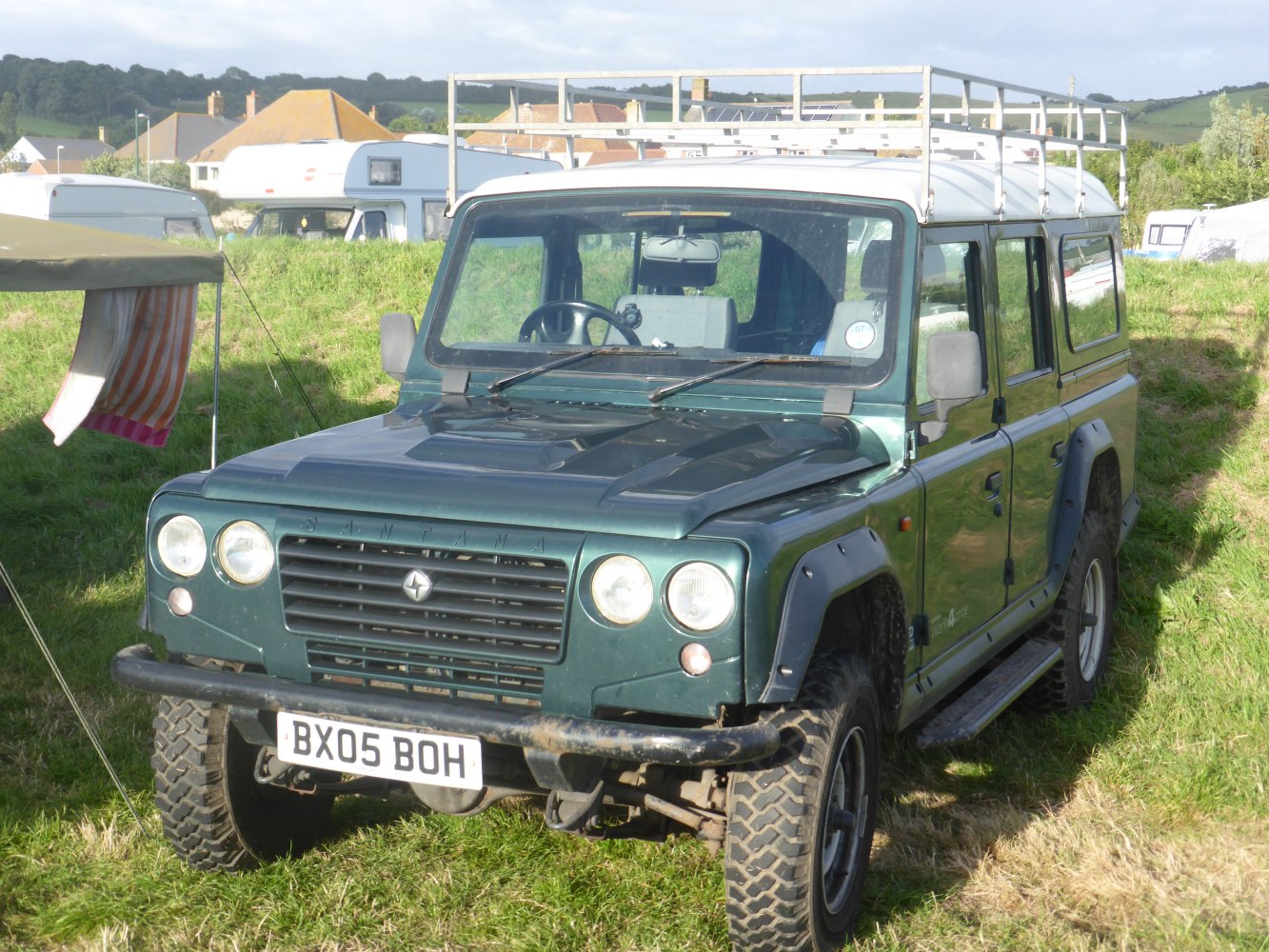 Rugged off-road SUV with roof rack and robust design