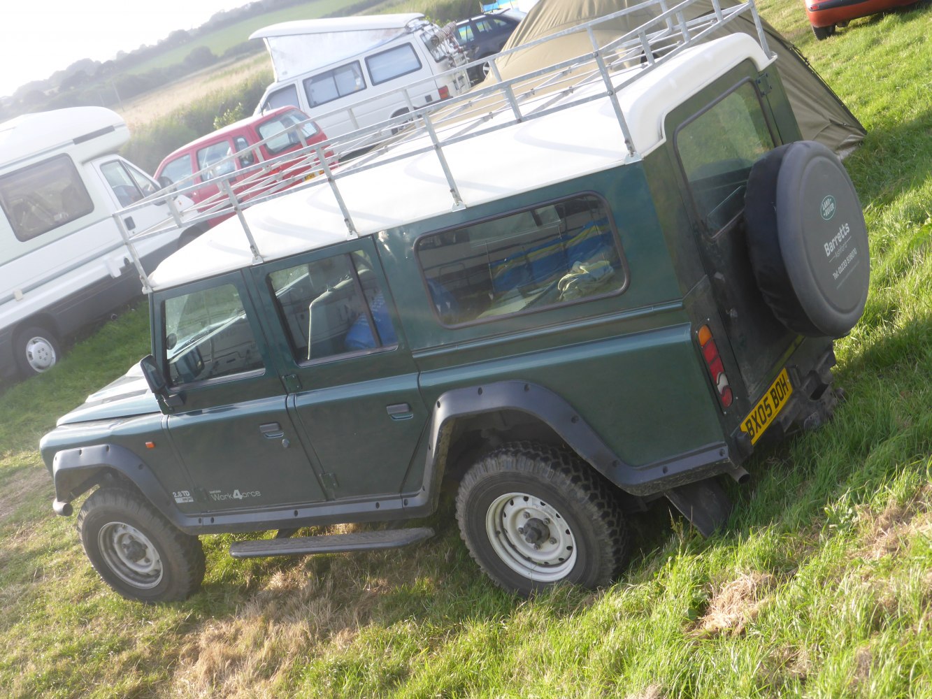 Off-road SUV side view with roof rack and rear spare tire