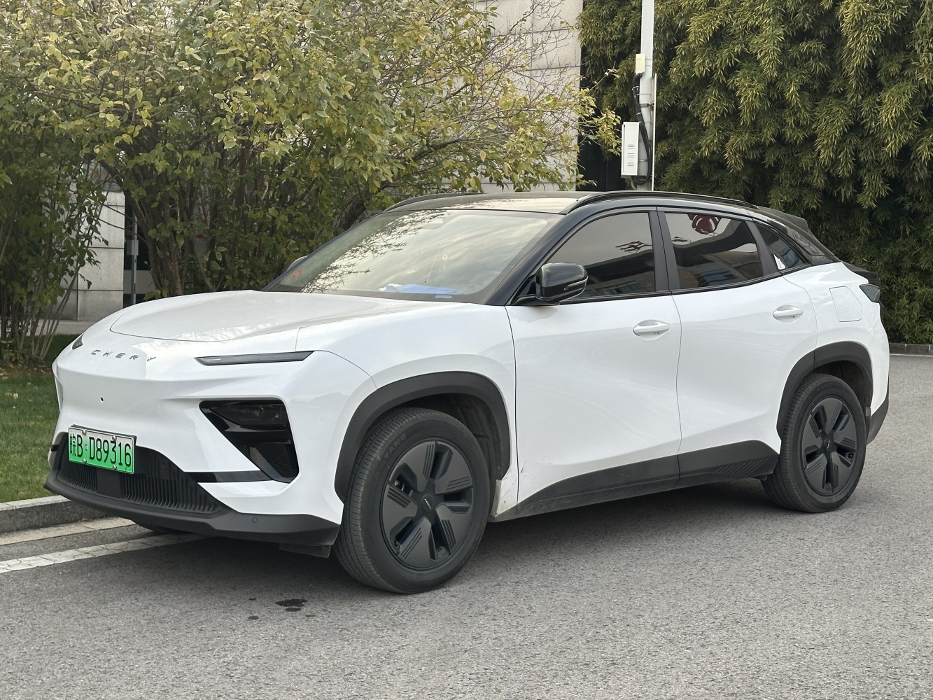 White electric SUV with black roof and sleek aerodynamic design