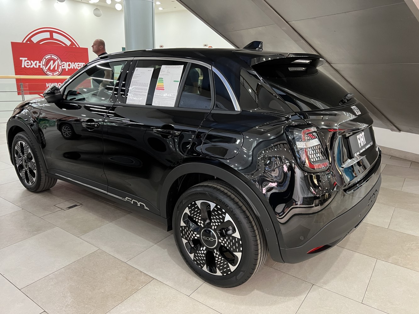 Rear side view with distinctive patterned wheels of a sleek compact car