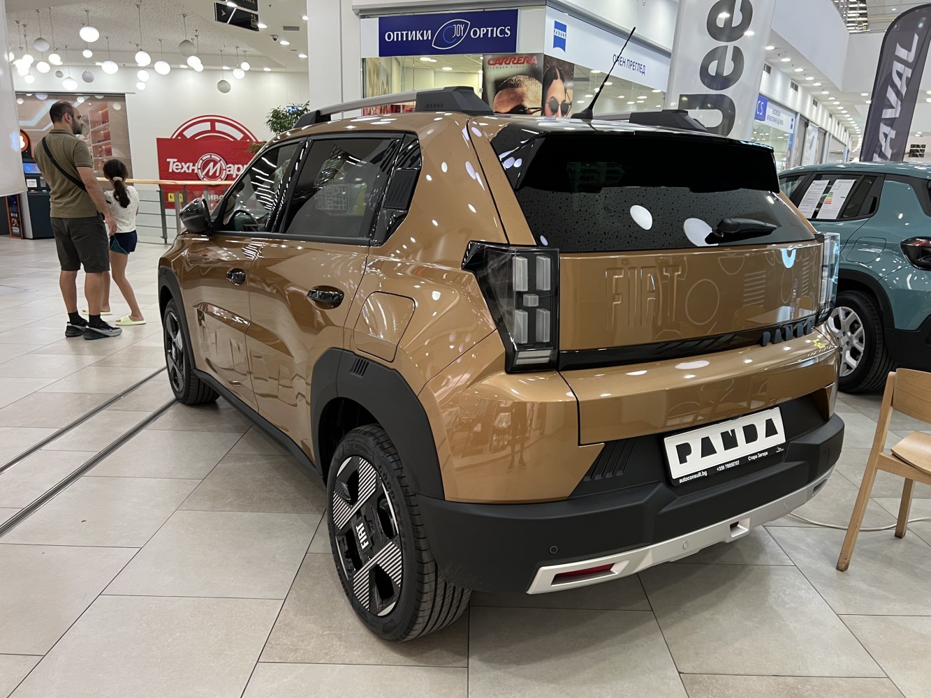 Brown compact car rear and side view with modern taillight design