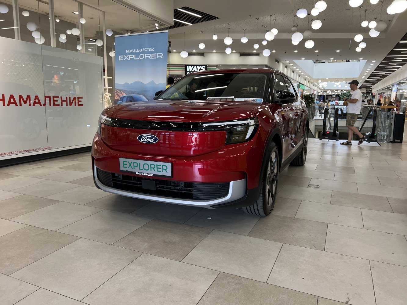Front view of a sleek modern electric SUV displayed indoors.