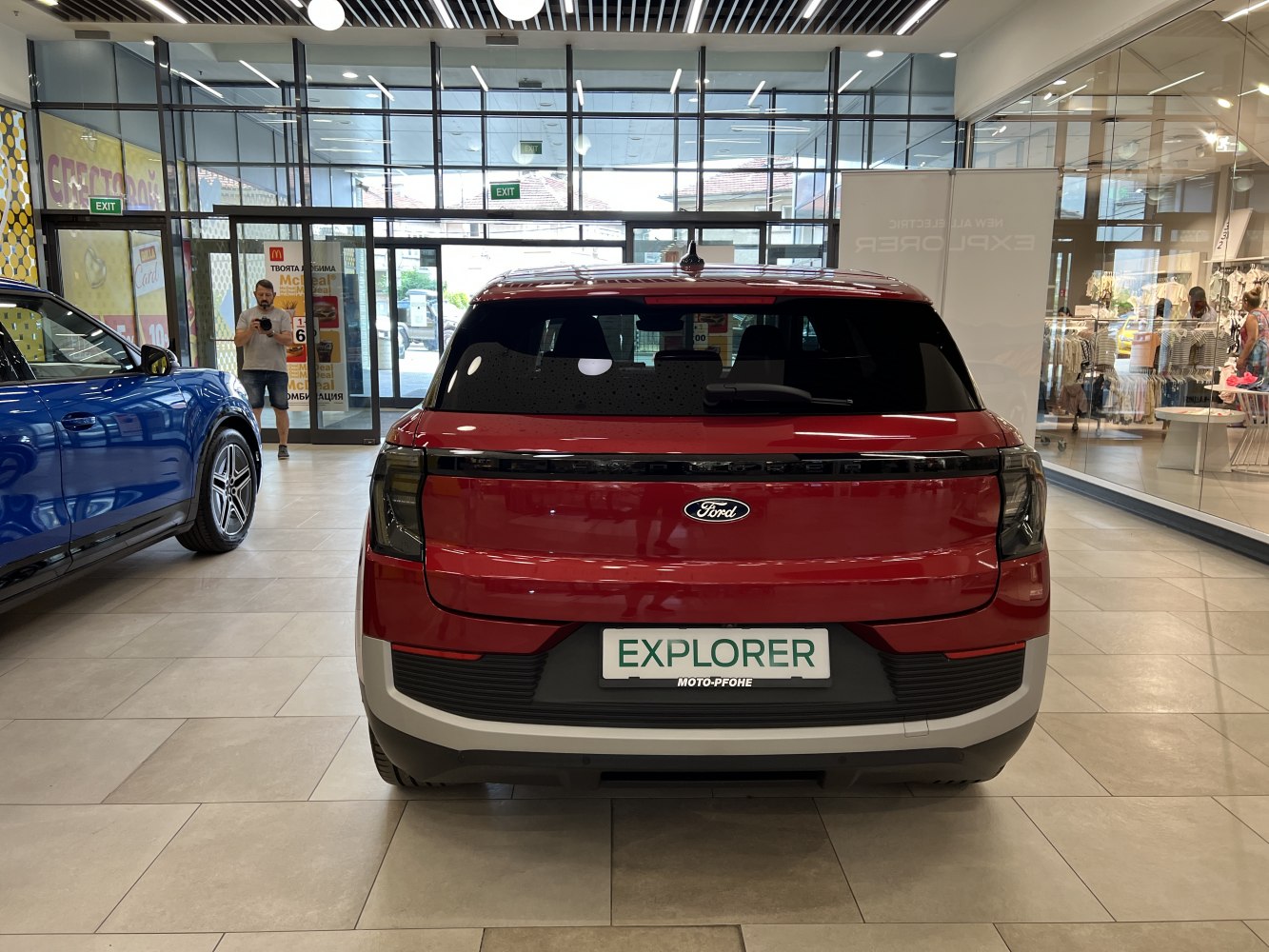 Red electric SUV rear with sleek tail lights and smooth rear hatch design