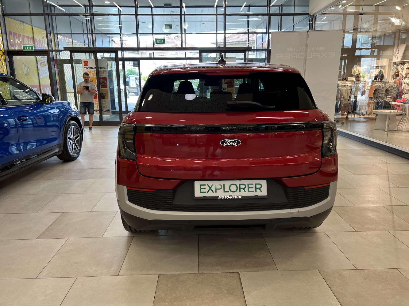 Rear view of an electric SUV with wide integrated tail light and rear hatch.