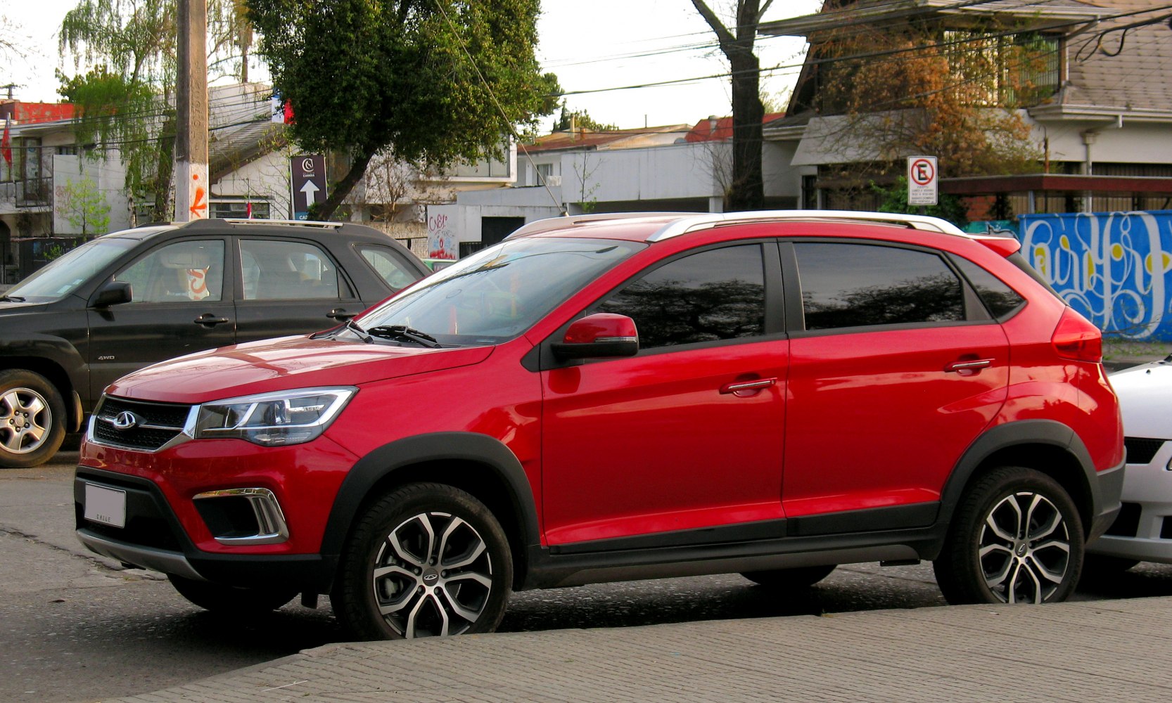Red compact SUV with alloy wheels and roof rails