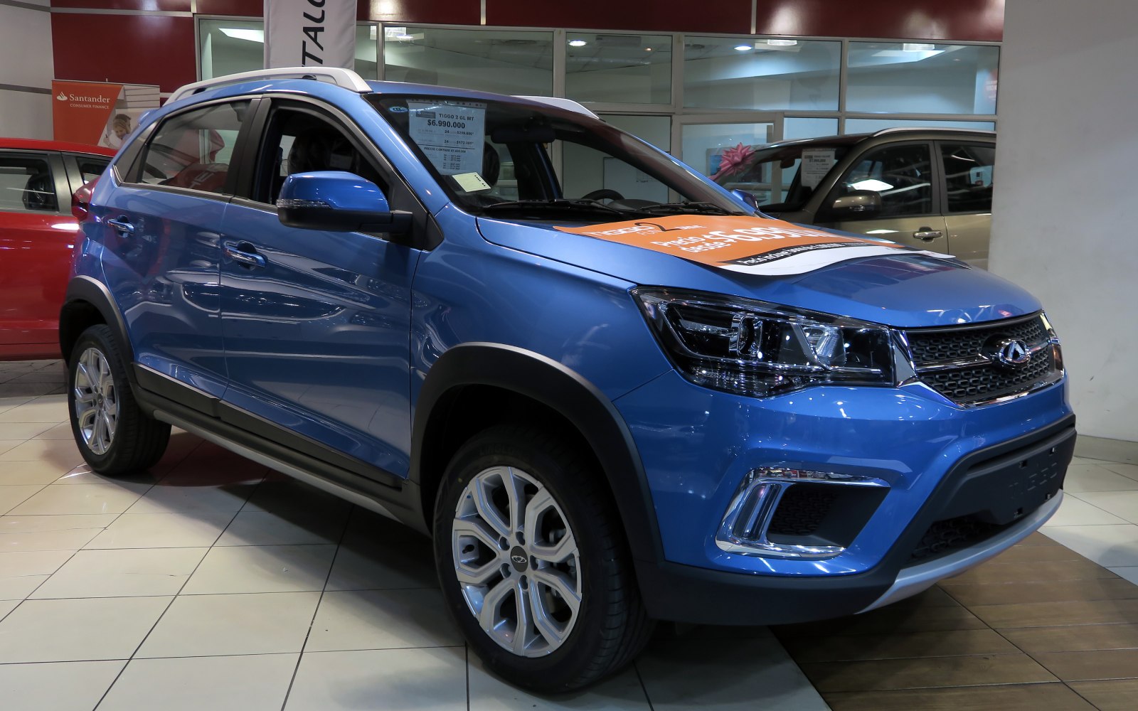 Front side view of blue compact SUV with LED headlights and alloy wheels