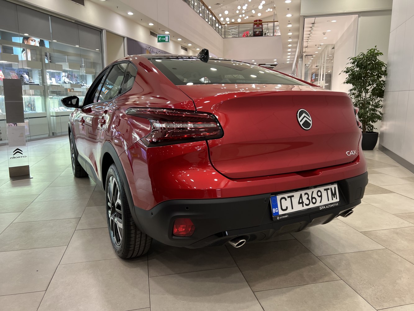 Rear view of a red hatchback with LED taillights and dual exhausts