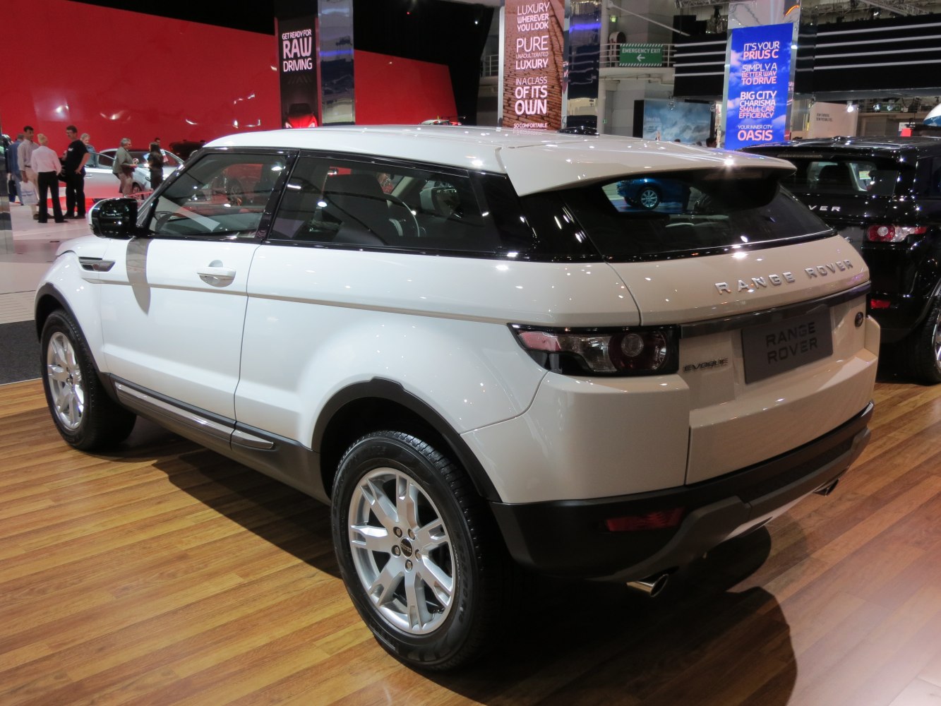 Rear side view of white compact luxury SUV with sharp lines and silver wheels