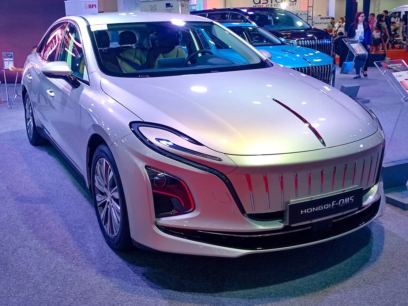 Close-up of a modern electric sedan with unique grille and sleek headlights